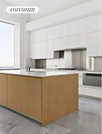 a kitchen with granite countertop a sink and white cabinets