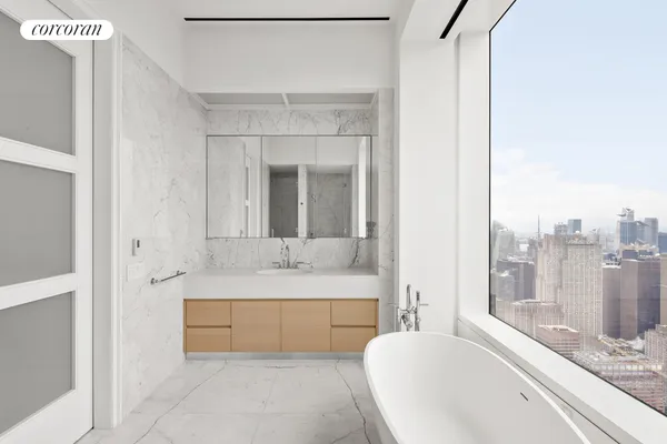 a bathroom with a large tub a shower and view