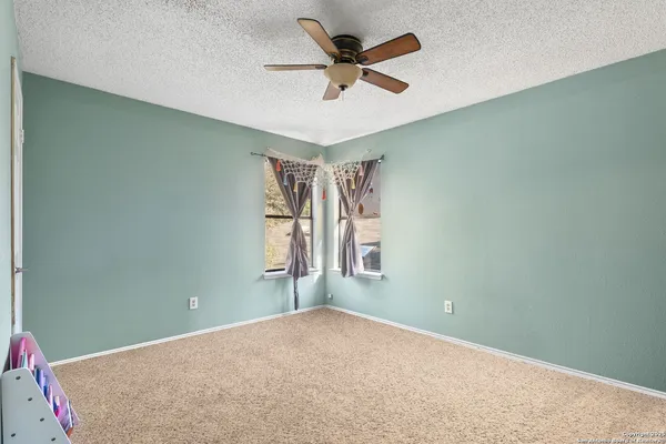 an empty room with closet and ceiling fan