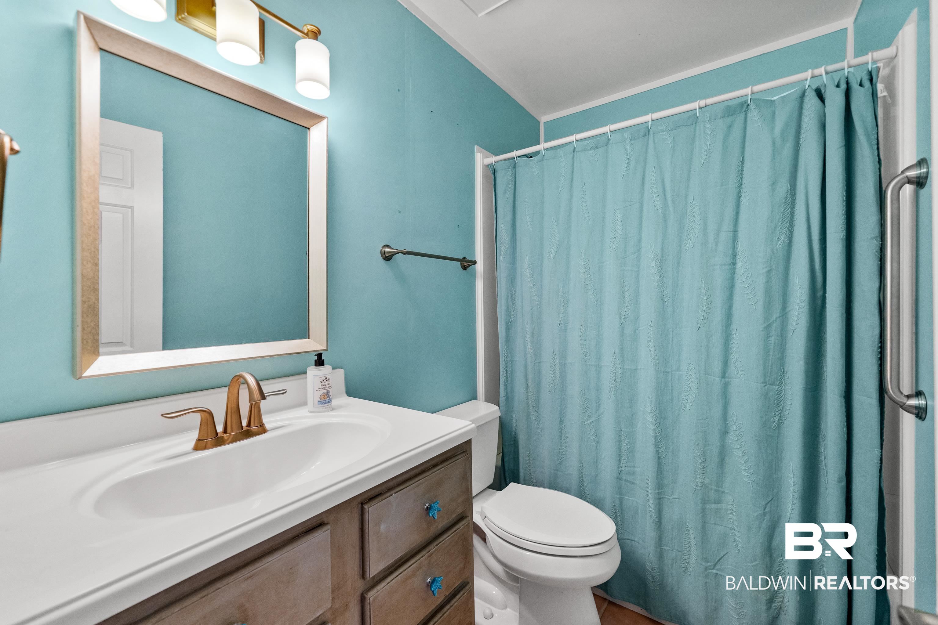1701 Regency Road, Unit 111 Gulf Shores, AL 36542 - Photo 22 of 29 Bathroom featuring vanity, toilet, and walk in shower