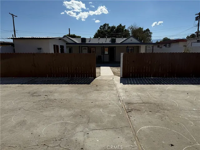 a view of a house with wooden fence