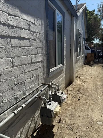 a kitchen with sink a microwave and cabinets