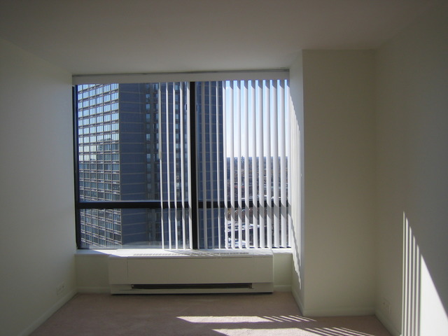 5415 North Sheridan Road, Unit 1715 Chicago, IL 60640 - Photo 8 of 24 a view of wooden floor and window in an empty room