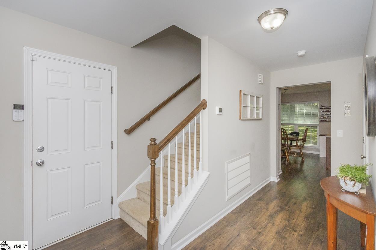108 Agnew Road Starr, SC 29684 - Photo 5 of 40 Luxury Laminate flooring, wide hallway and stairs leading to upstairs bedrooms and laundry.