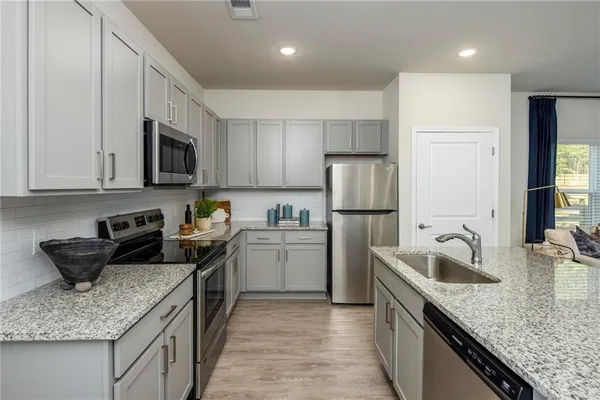 a kitchen with a sink stove and refrigerator