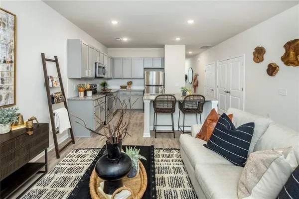 a living room with furniture a rug and a chandelier