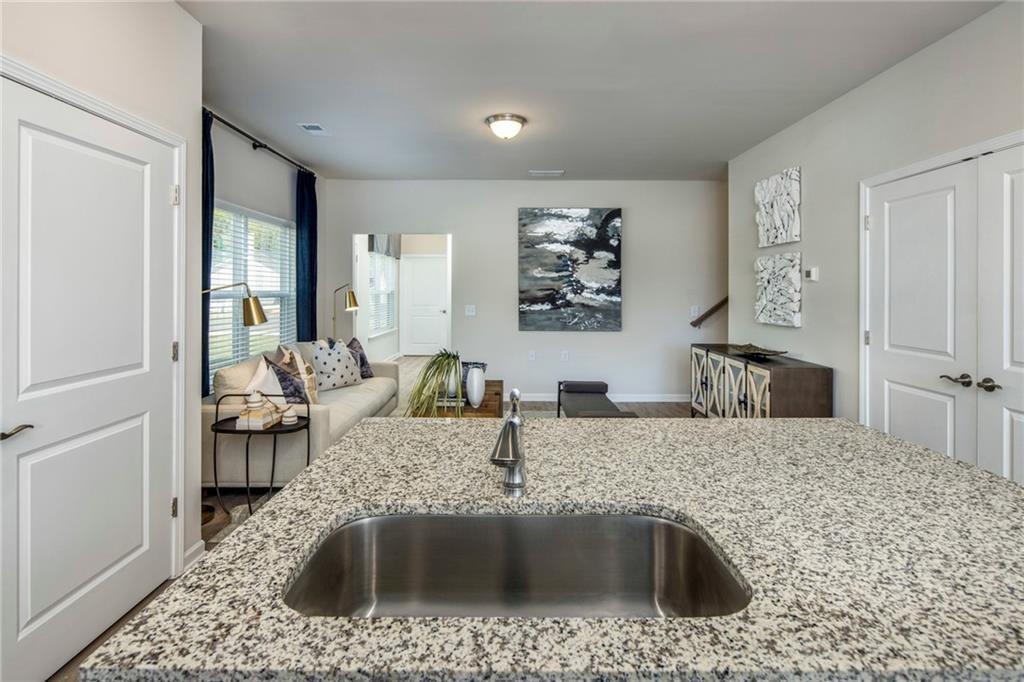 100 Cottage Way, Unit NUTMEG Hampton, GA 30228 - Photo 18 of 44 a kitchen with a sink a stove and cabinets