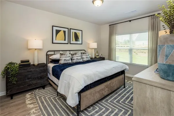 a bedroom with a large bed and a window