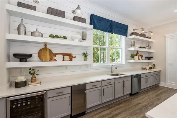 a kitchen with a sink a window and cabinets