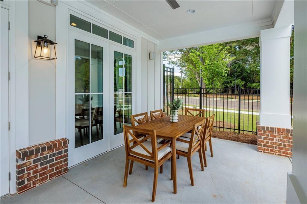 100 Cottage Way, Unit NUTMEG Hampton, GA 30228 - Photo 43 of 44 a view of a patio with a table and chairs