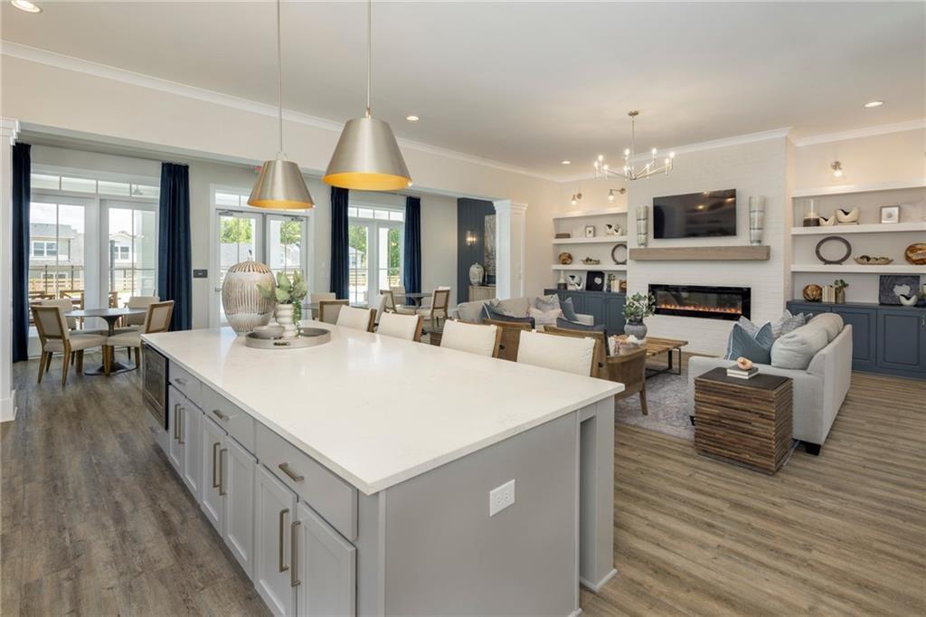 100 Cottage Way, Unit NUTMEG Hampton, GA 30228 - Photo 6 of 44 a large white kitchen with stainless steel appliances