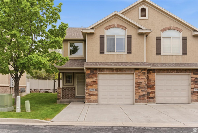 2082 Evans Cove Loop Layton, UT 84041 - Photo 1 of 25 View of front of house featuring stone siding, a shingled roof, covered porch, and an attached garage