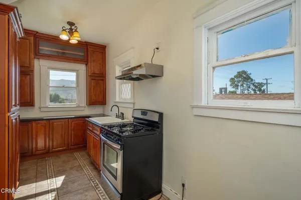 a kitchen with stainless steel appliances a stove and a window