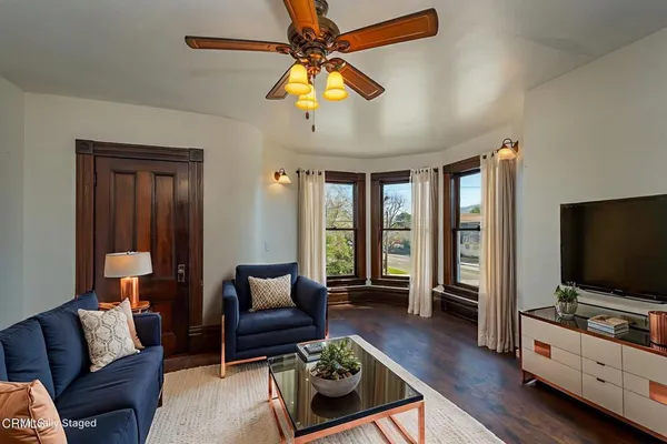 a living room with furniture and a flat screen tv