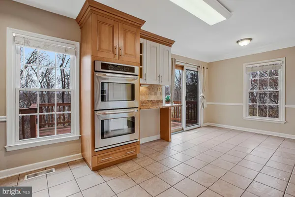 a view of kitchen with windows and refrigerator