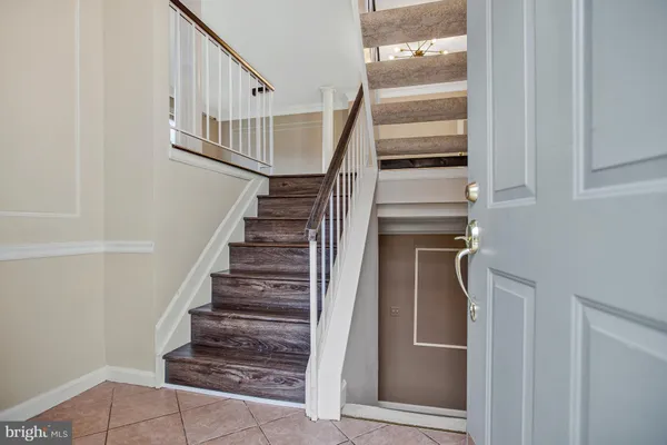 a view of entryway and hall with wooden floor