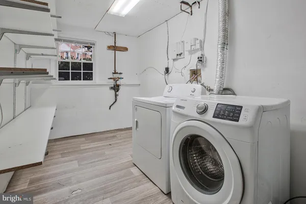 a utility room with cabinets dryer and washer