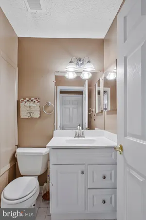 a view of a house with wooden deck and furniture