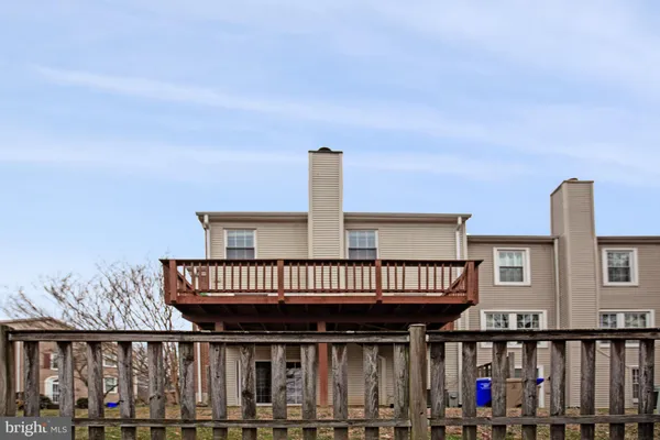 a view of a backyard with wooden fence