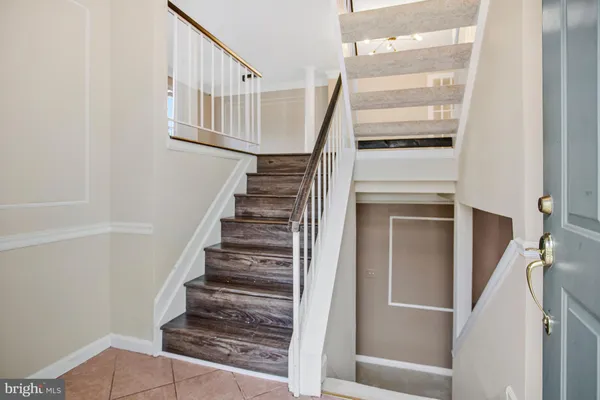 a view of staircase with white walls and railing