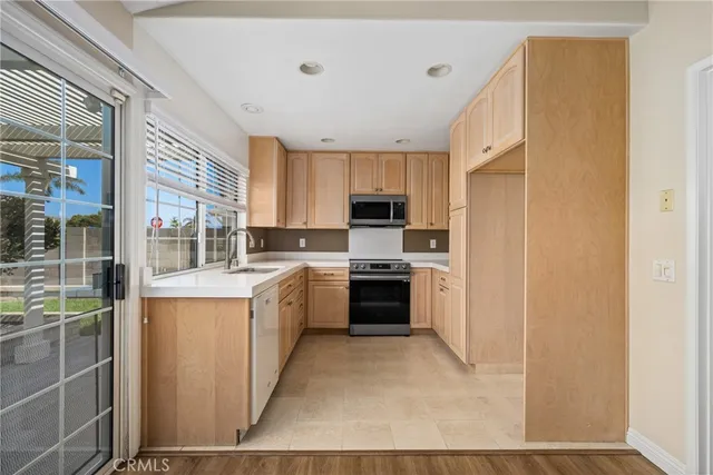 a large kitchen with cabinets and stainless steel appliances