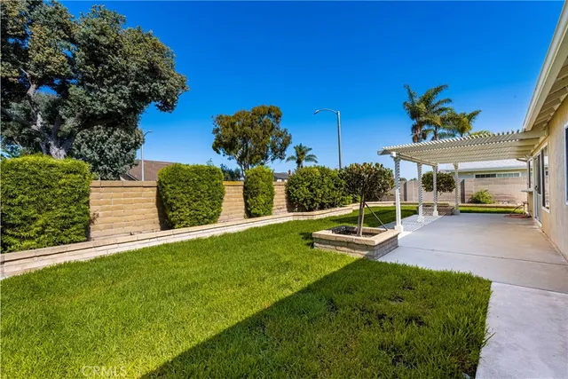 a view of a patio with table and chairs and potted plants