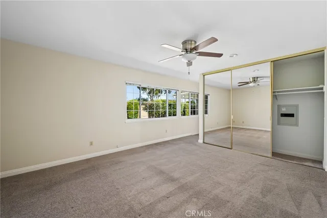 an empty room with windows and closet