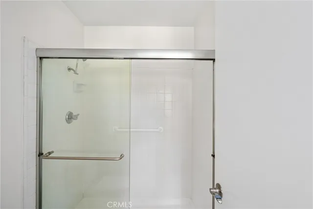 a bathroom with a glass shower door