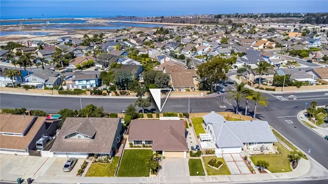 an aerial view of a house with yard swimming pool and ocean view