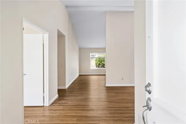 a view of hallway with wooden floor