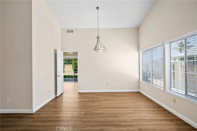 a view of a room with wooden floor and windows