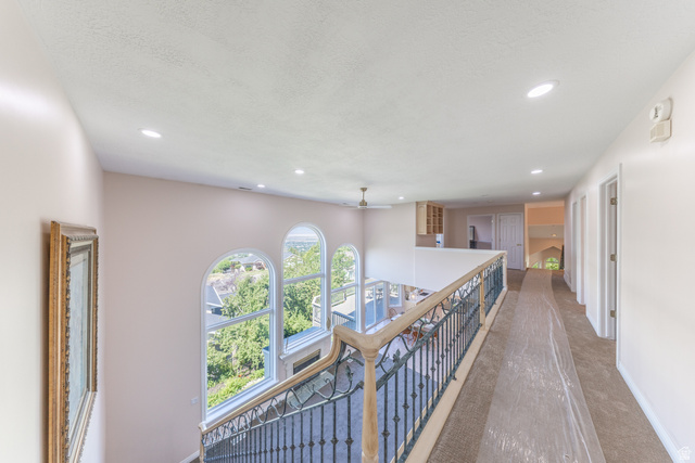144 Bountiful Boulevard Bountiful, UT 84010 - Photo 22 of 28 Corridor featuring an upstairs landing, recessed lighting, a textured ceiling, and carpet floors