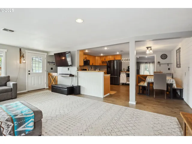 a living room with furniture and a kitchen