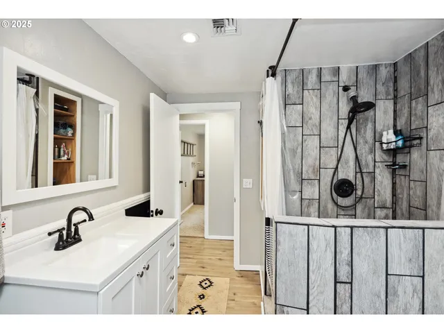 a bathroom with a sink double vanity and a mirror
