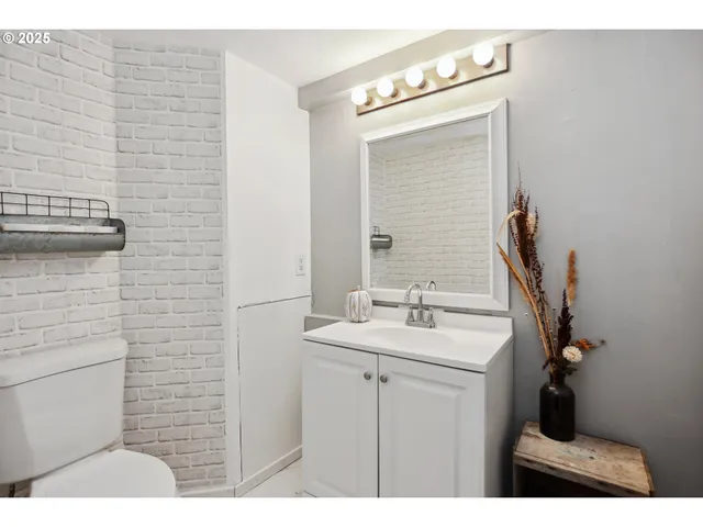 a bathroom with a sink a toilet and mirror