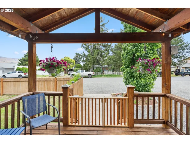 a view of a wooden chairs and table in the patio