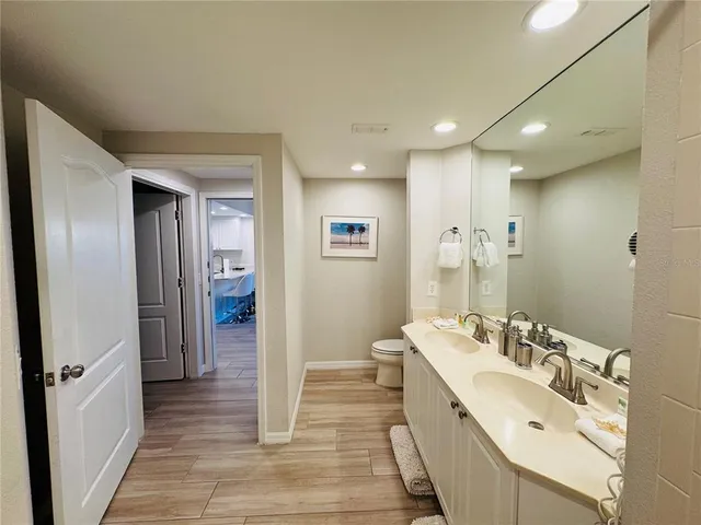 a bathroom with a double vanity sink and mirror