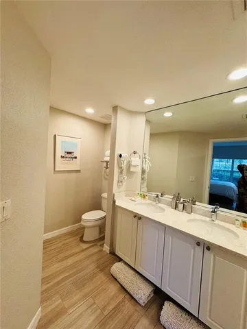 a bathroom with a double vanity sink and a mirror