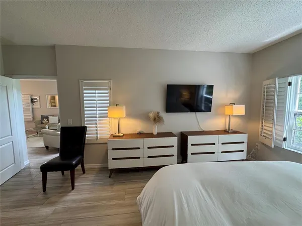 a bedroom with furniture and flat screen tv