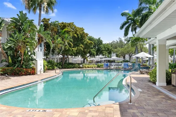 a view of a swimming pool with lounge chair