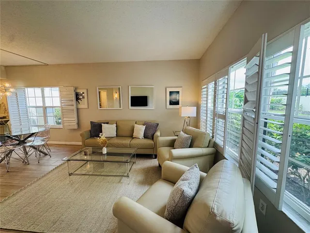 a living room with furniture and large windows