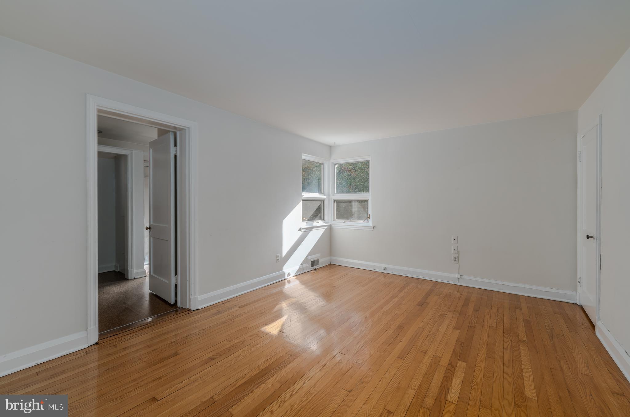 1012 Poplar Hill Road Baltimore, MD 21210 - Photo 15 of 42 a view of empty room with wooden floor and ceiling fan