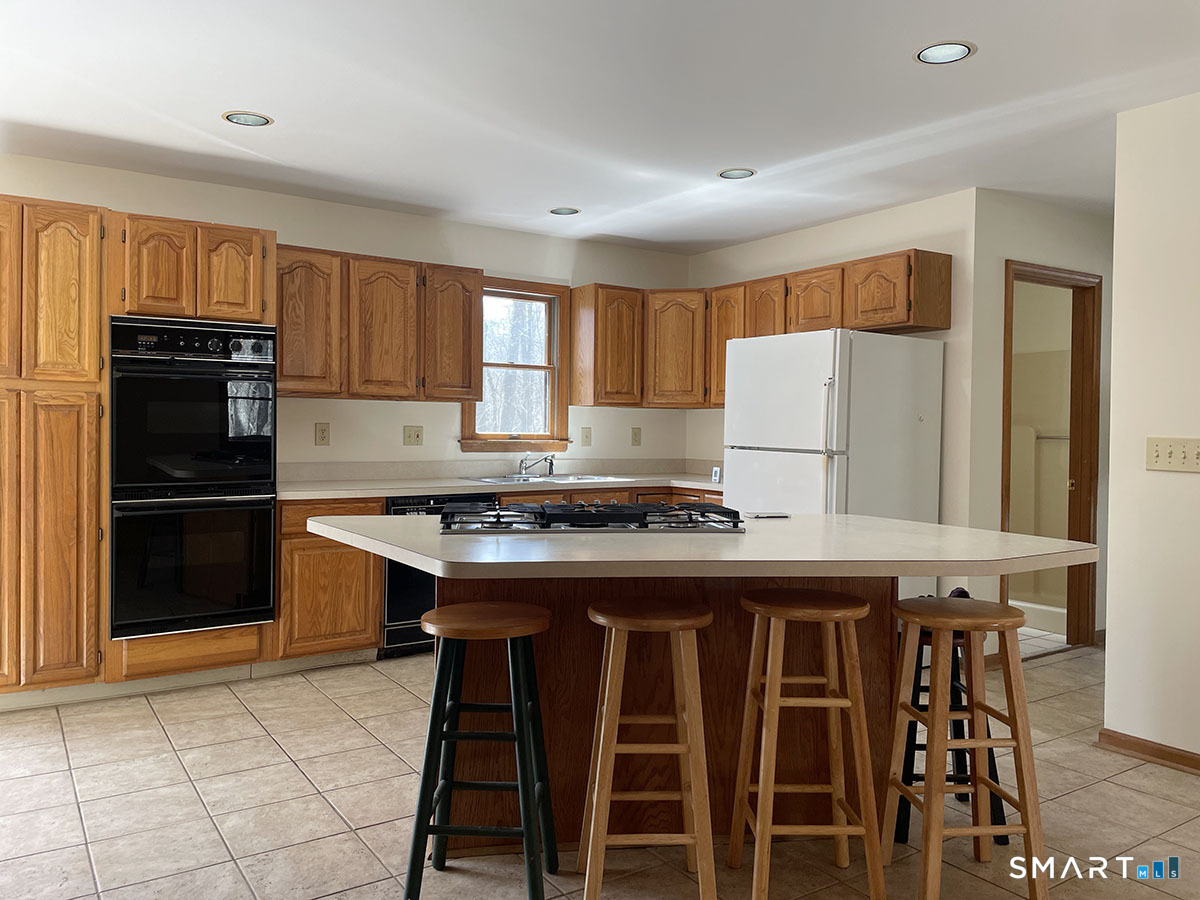 1315 Purchase Brook Road Southbury, CT 06488 - Photo 16 of 41 a kitchen with a stove a refrigerator and a refrigerator
