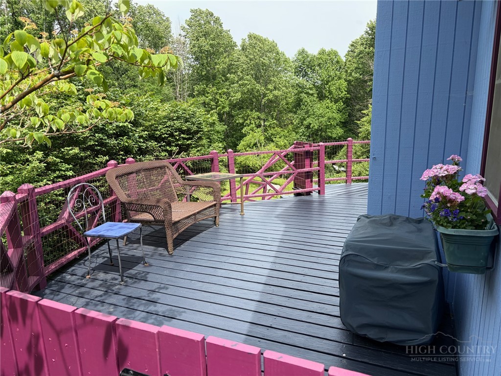 873 Silverleaf Road Zionville, NC 28698 - Photo 11 of 49 a view of a deck with chairs and potted plants