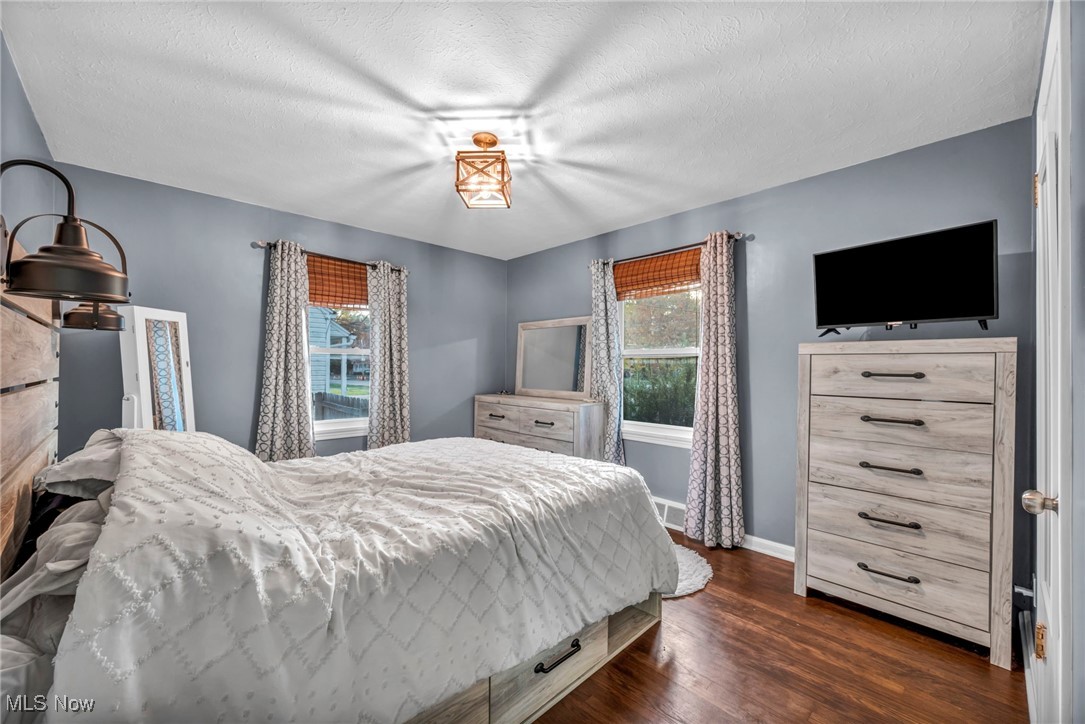 149 Jaycox Road Avon Lake, OH 44012 - Photo 24 of 42 Bedroom featuring dark wood-style floors and a textured ceiling