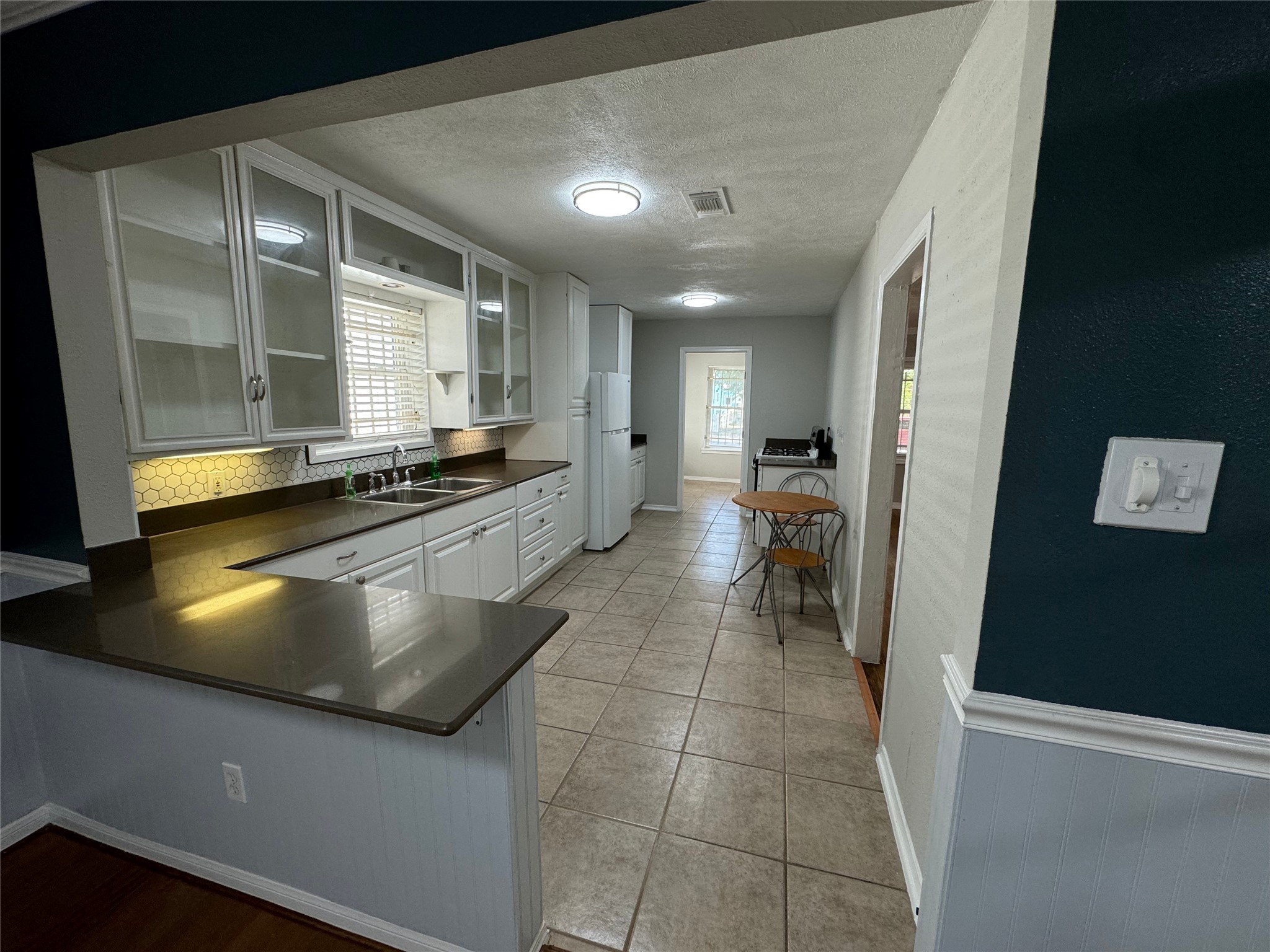 a kitchen with stainless steel appliances a stove a sink and a refrigerator