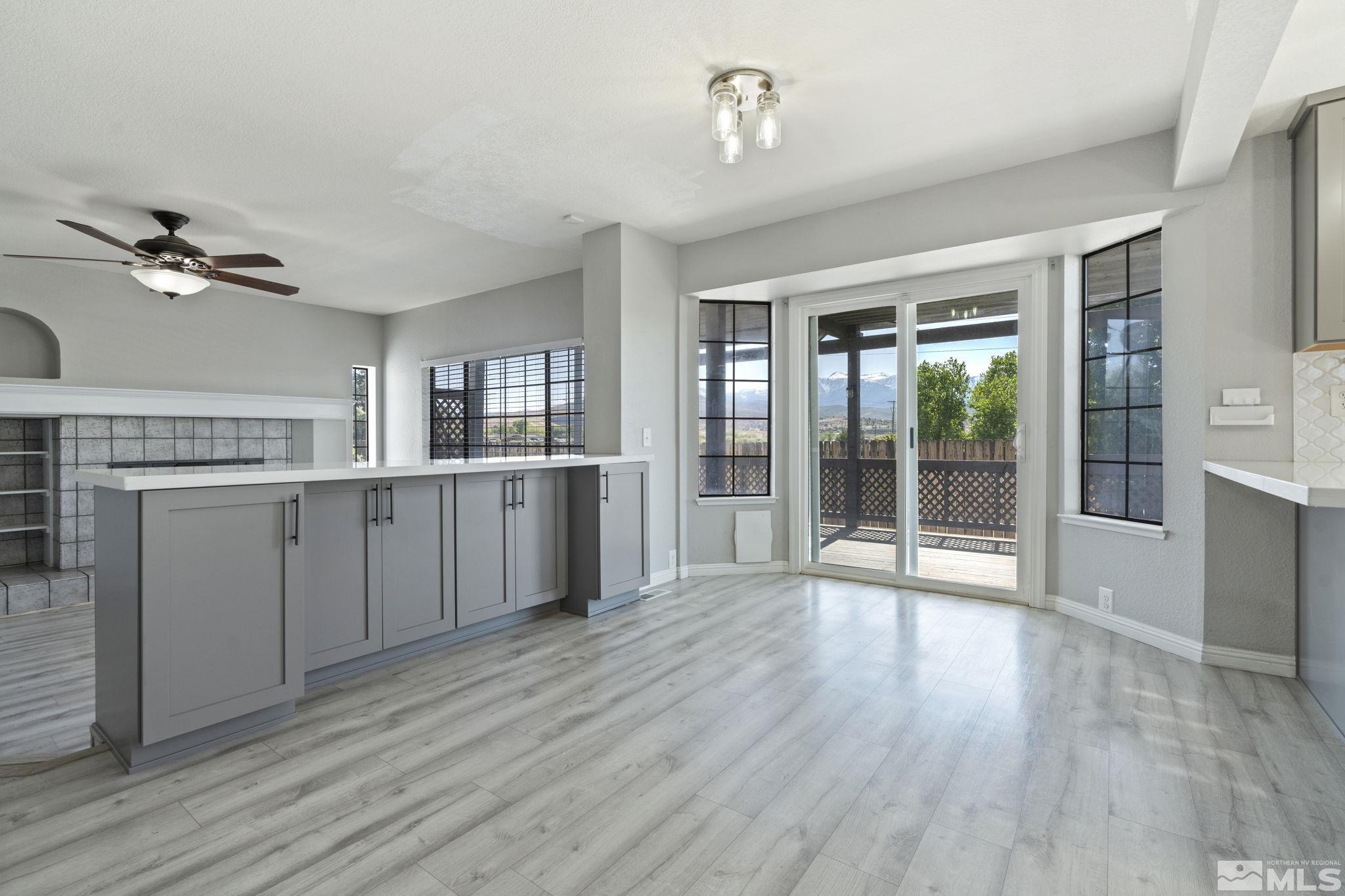 14050 Riata Circle Reno, NV 89521 - Photo 12 of 33 a view of a kitchen with wooden floor and a ceiling fan