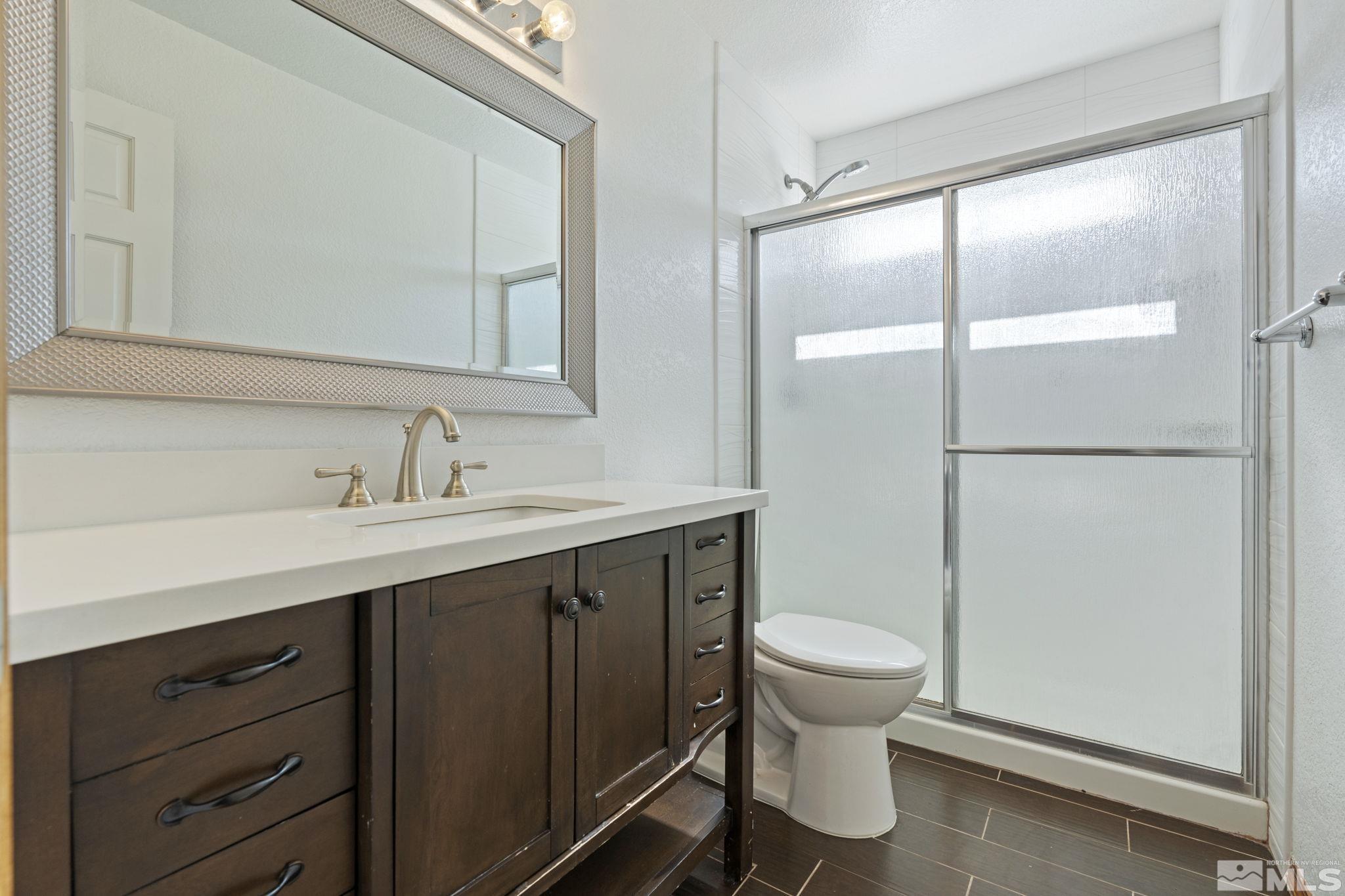 14050 Riata Circle Reno, NV 89521 - Photo 21 of 33 a bathroom with a sink a toilet and shower