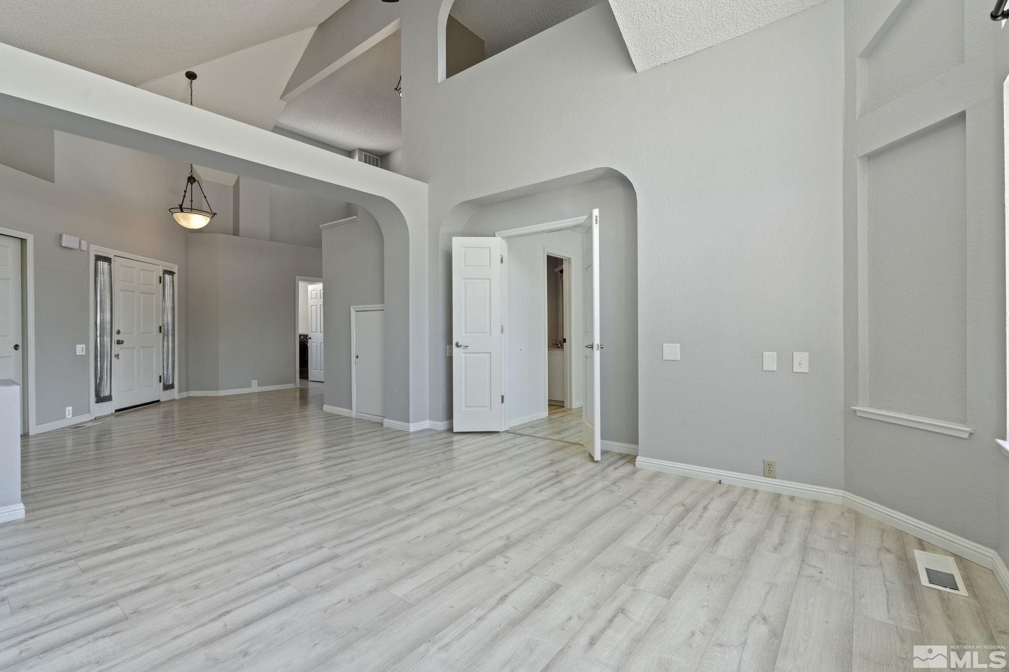 14050 Riata Circle Reno, NV 89521 - Photo 3 of 33 a view of an empty room with wooden floor