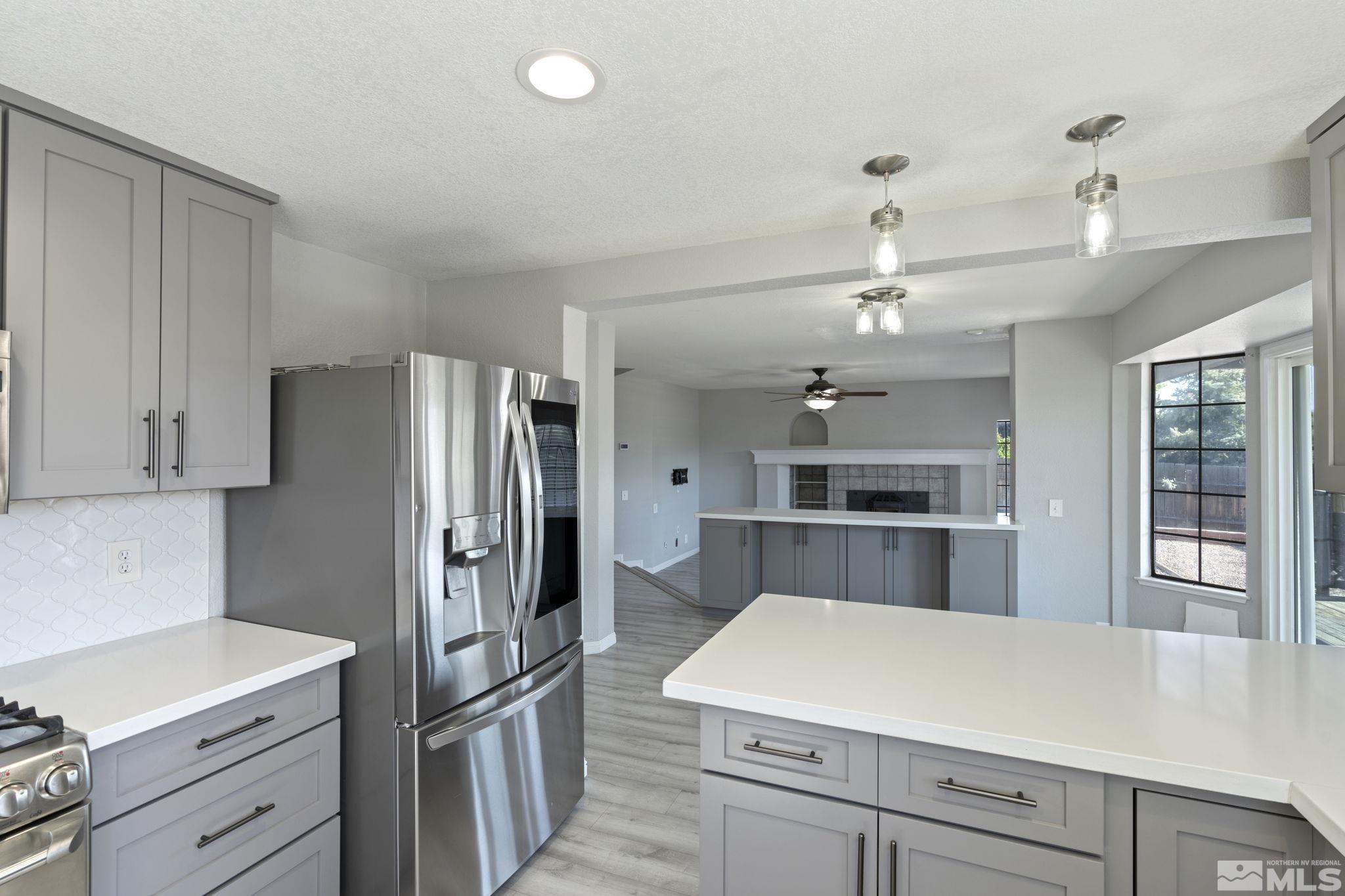 14050 Riata Circle Reno, NV 89521 - Photo 6 of 33 a kitchen with a refrigerator and a sink